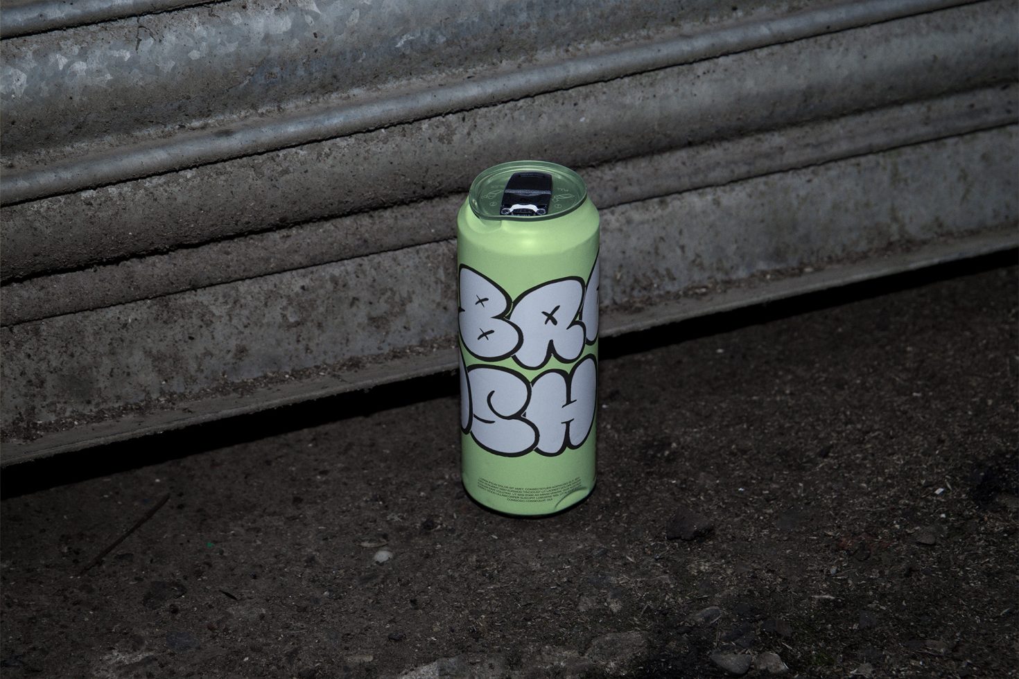 Urban styled spray paint can with graphic design mockup, on gritty concrete, ideal for street art presentations.